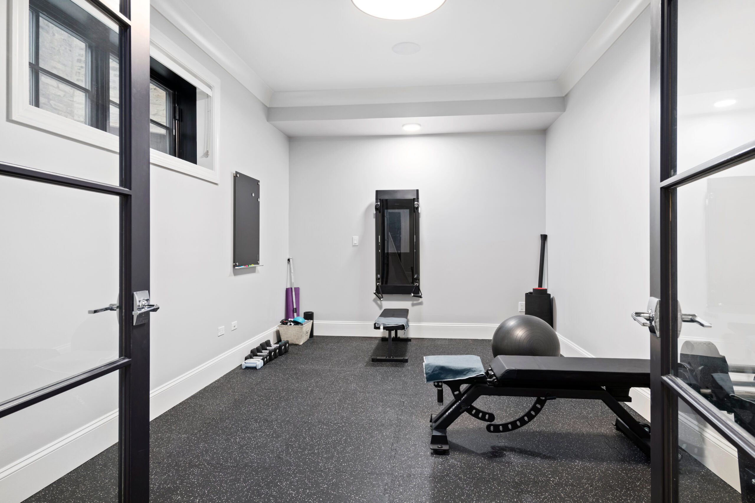 Simple Home Gym. Small room in basement with workout equipment. Small room in the basement with workout equipment.